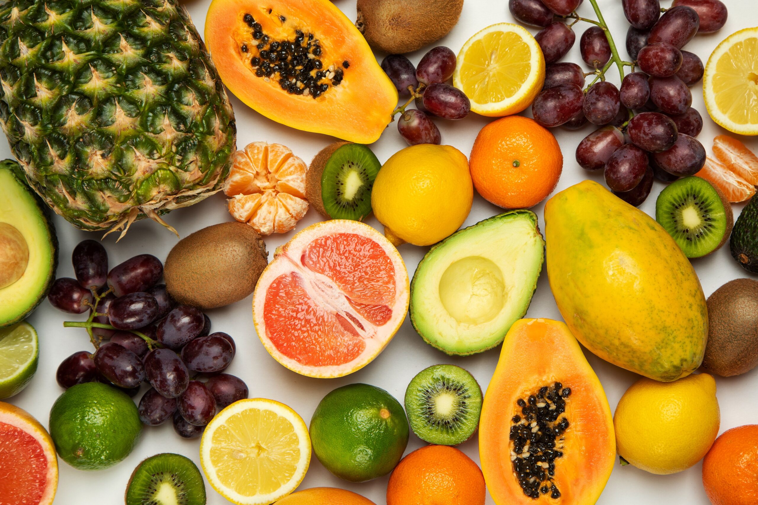 A colorful assortment of fresh and healthy fruits displayed in a flat lay arrangement.